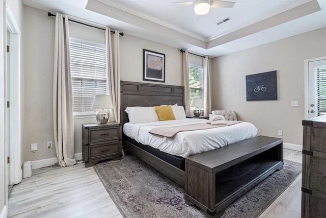 1515/1517 Belle Royal Ct, Bentonville, AR 72712 - bedroom with crown molding, light wood-style flooring, a raised ceiling, multiple windows, and baseboards