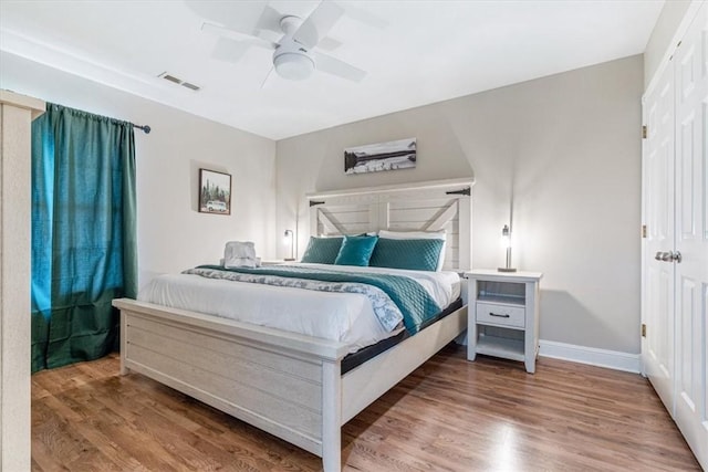 1515/1517 Belle Royal Ct, Bentonville, AR 72712 - bedroom featuring wood finished floors, baseboards, and ceiling fan