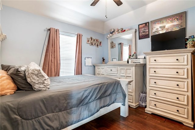 bedroom with ceiling fan, vaulted ceiling, dark hardwood / wood-style floors, and multiple windows