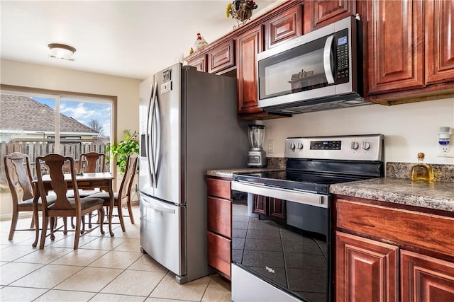 kitchen featuring light tile patterned floors and appliances with stainless steel finishes