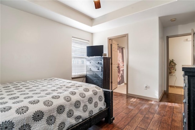 bedroom featuring ceiling fan, wood-type flooring, and ensuite bath