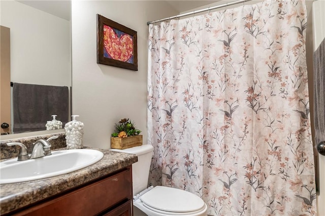 bathroom featuring toilet and vanity