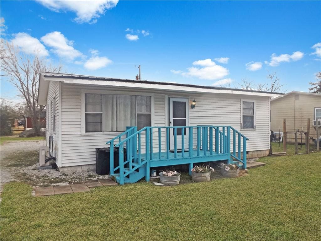 rear view of property featuring a yard