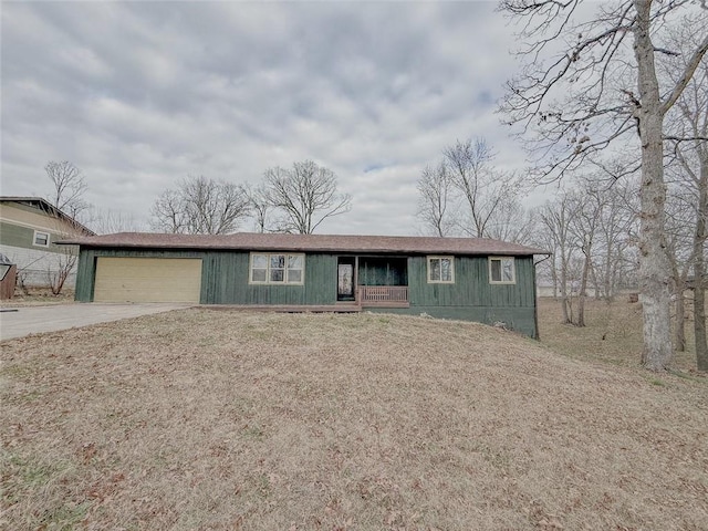 ranch-style home with covered porch and a garage