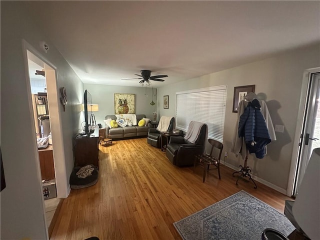 living room featuring ceiling fan and hardwood / wood-style floors