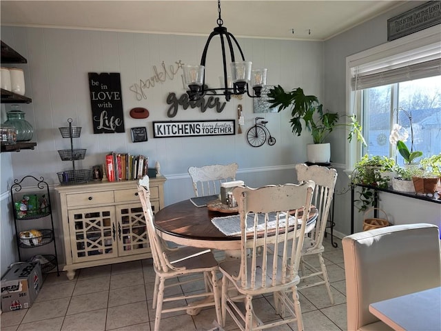 dining area featuring tile patterned floors and crown molding