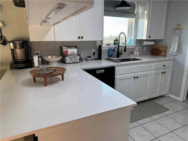 kitchen with light tile patterned flooring, a sink, light countertops, white cabinets, and dishwasher