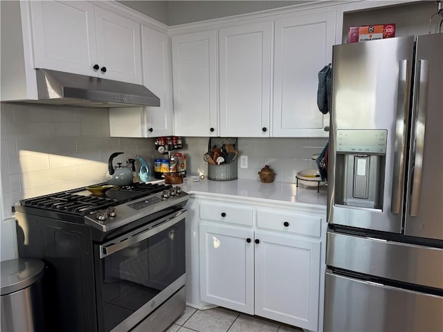 kitchen featuring stainless steel appliances, light countertops, under cabinet range hood, white cabinetry, and backsplash