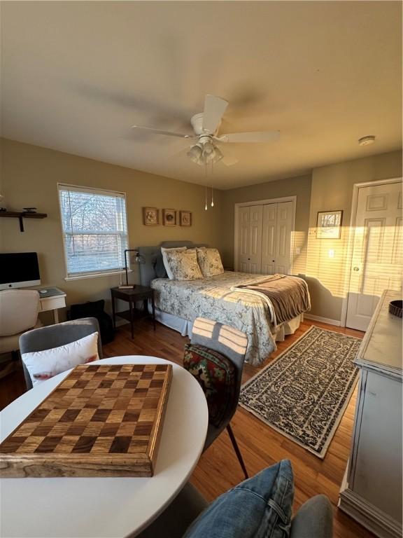 bedroom featuring ceiling fan, a closet, and wood finished floors