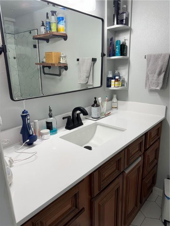 bathroom with vanity, a stall shower, and tile patterned flooring