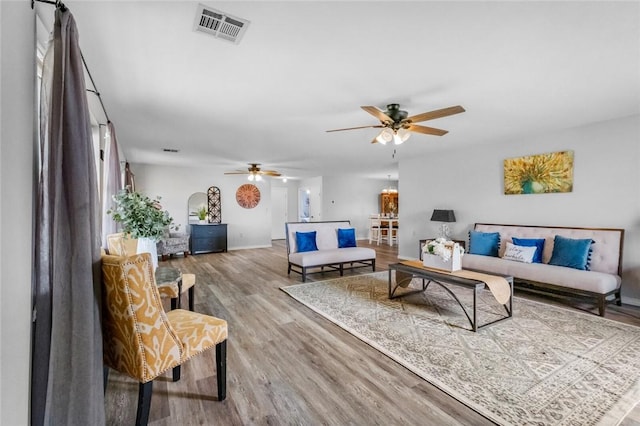 living room featuring hardwood / wood-style floors and ceiling fan