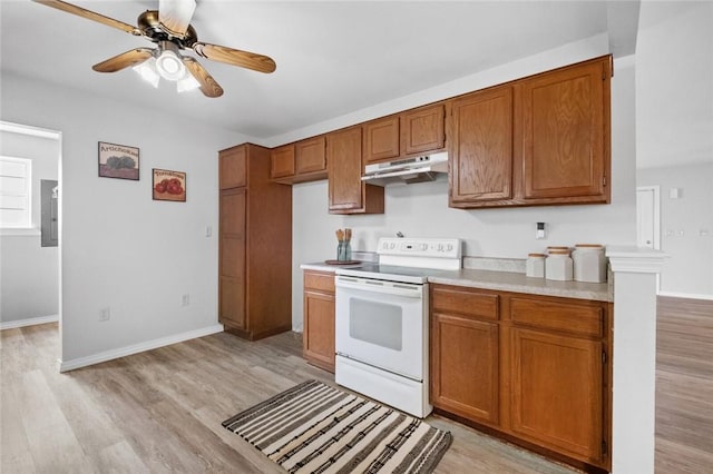 kitchen featuring light wood-type flooring, white electric stove, and ceiling fan