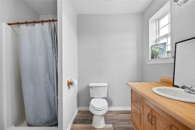 bathroom with hardwood / wood-style floors, vanity, toilet, and a shower with shower curtain