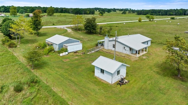 birds eye view of property with a rural view