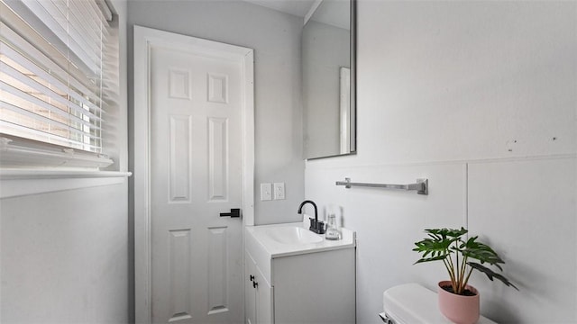 bathroom with toilet and vanity