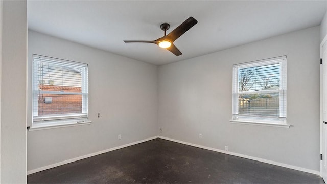 spare room featuring ceiling fan and plenty of natural light