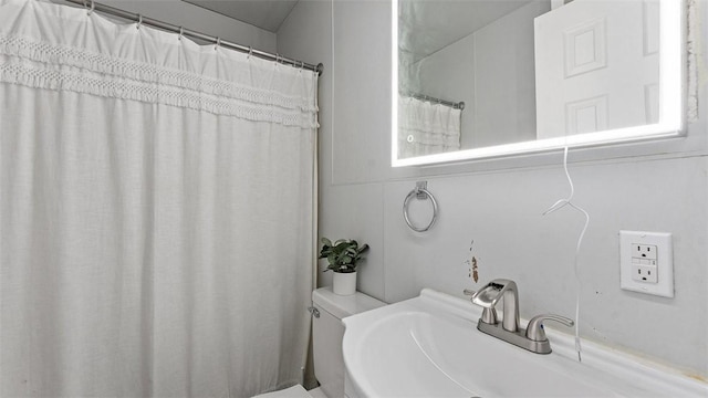 bathroom featuring sink and toilet