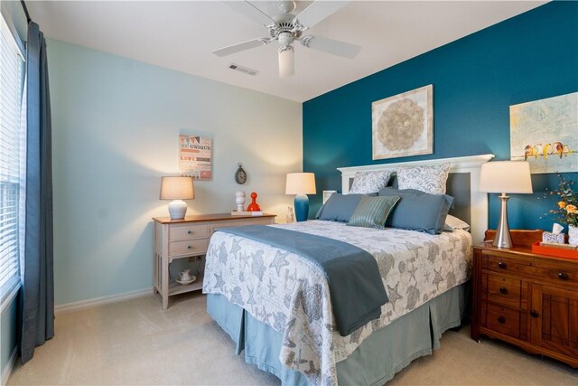 bedroom featuring light colored carpet and ceiling fan