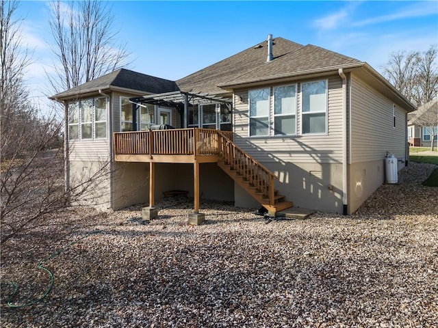 back of house with a sunroom, a pergola, and a wooden deck