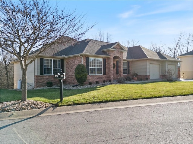 single story home featuring a front lawn and a garage