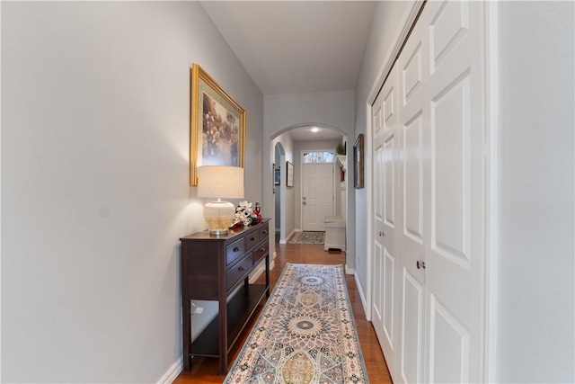 corridor with dark hardwood / wood-style flooring