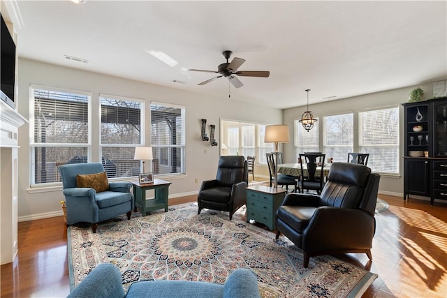 living room with hardwood / wood-style flooring and ceiling fan