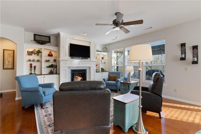 living room with ceiling fan and dark hardwood / wood-style flooring