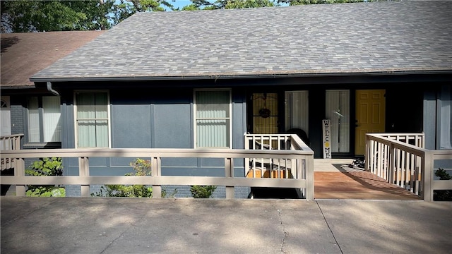 view of exterior entry featuring covered porch