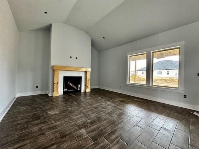 unfurnished living room with vaulted ceiling