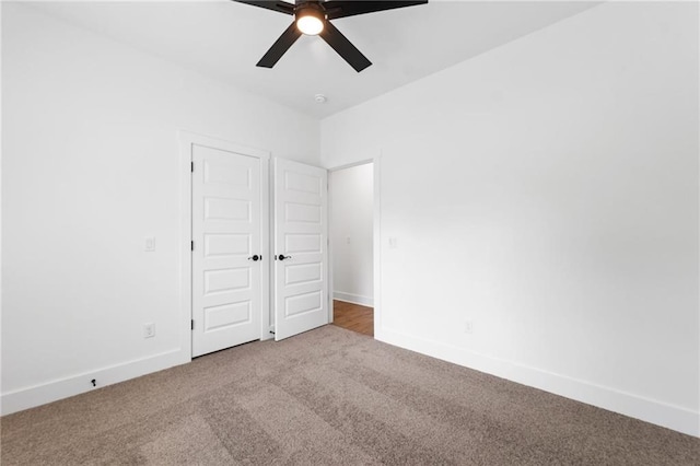 unfurnished bedroom with carpet flooring, a closet, and ceiling fan