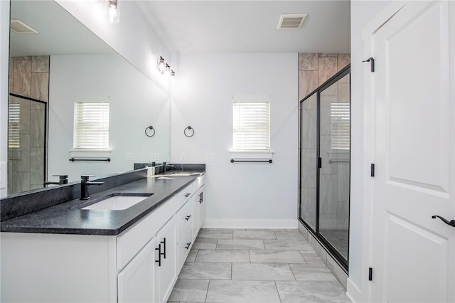 full bathroom featuring marble finish floor, plenty of natural light, visible vents, and a sink