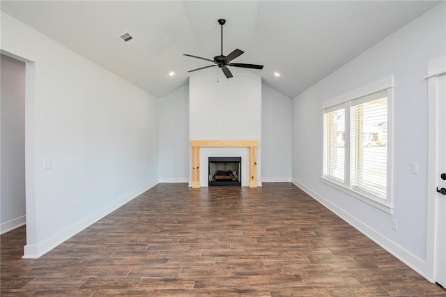 unfurnished living room with lofted ceiling, a fireplace, visible vents, baseboards, and dark wood finished floors