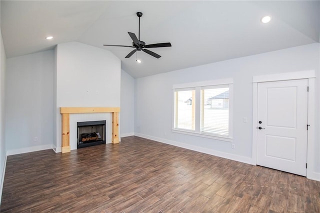 unfurnished living room with a fireplace, lofted ceiling, recessed lighting, dark wood-type flooring, and a ceiling fan