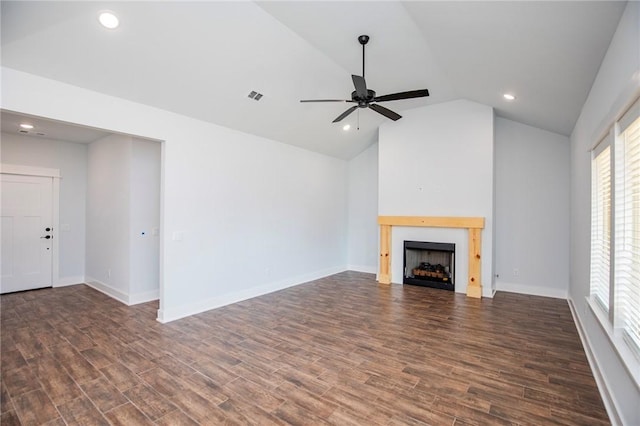 unfurnished living room with lofted ceiling, a fireplace, visible vents, and dark wood finished floors