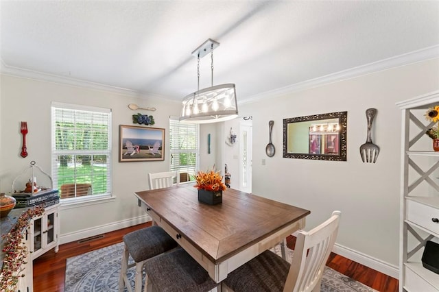 dining space with dark hardwood / wood-style floors and ornamental molding