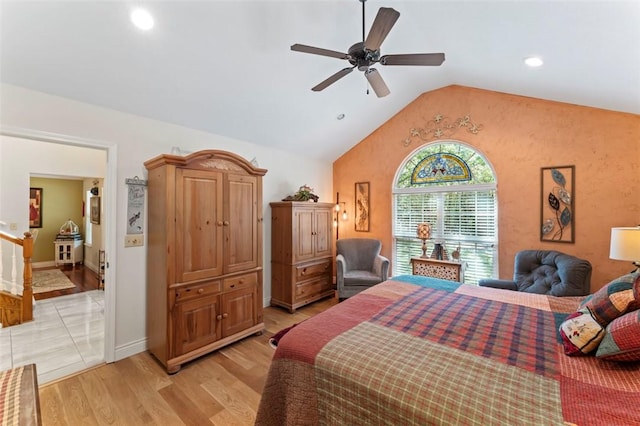 bedroom featuring ceiling fan, light hardwood / wood-style flooring, and vaulted ceiling