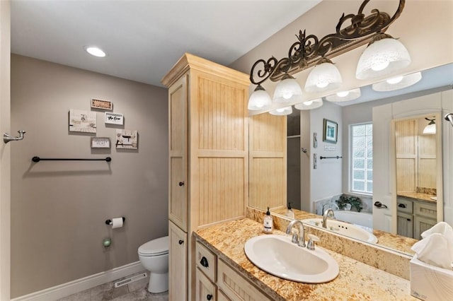 bathroom featuring vanity, toilet, and a bathing tub