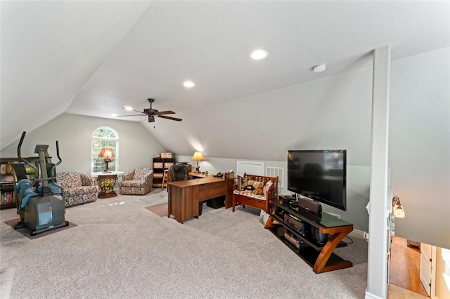 living room featuring ceiling fan, light carpet, and vaulted ceiling