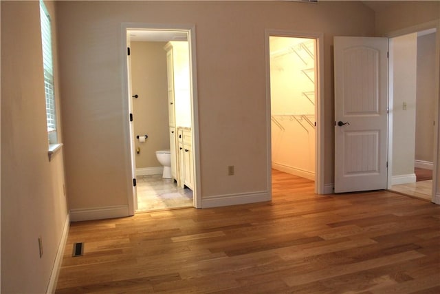 635 Ranchview Rd, Ridgedale, MO 65739 - unfurnished bedroom featuring light wood-style floors, connected bathroom, a spacious closet, and a closet