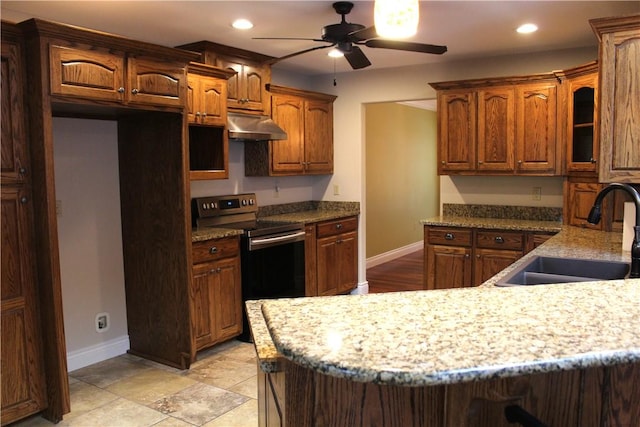 635 Ranchview Rd, Ridgedale, MO 65739 - kitchen with stainless steel range with electric cooktop, under cabinet range hood, ceiling fan, recessed lighting, and glass insert cabinets