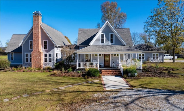 view of front of home featuring covered porch and a front lawn