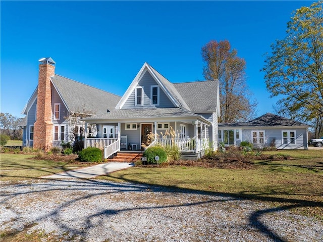 view of front of property with a front yard and a porch