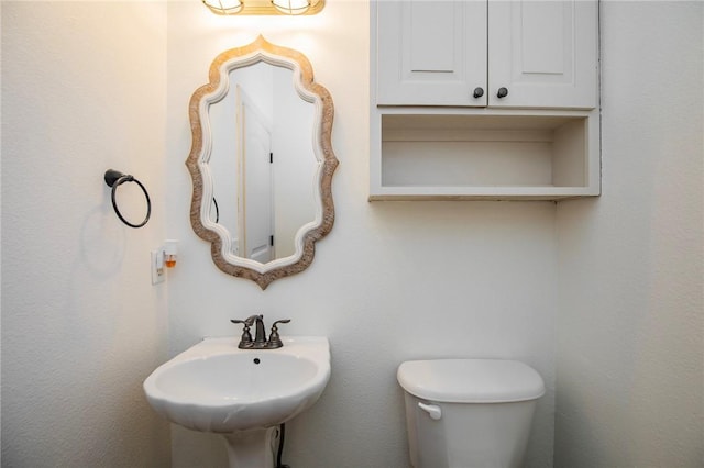 bathroom with toilet and sink