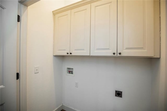 clothes washing area featuring hookup for a washing machine, cabinets, and hookup for an electric dryer