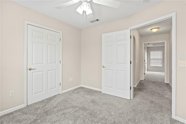 unfurnished bedroom with light colored carpet and ceiling fan