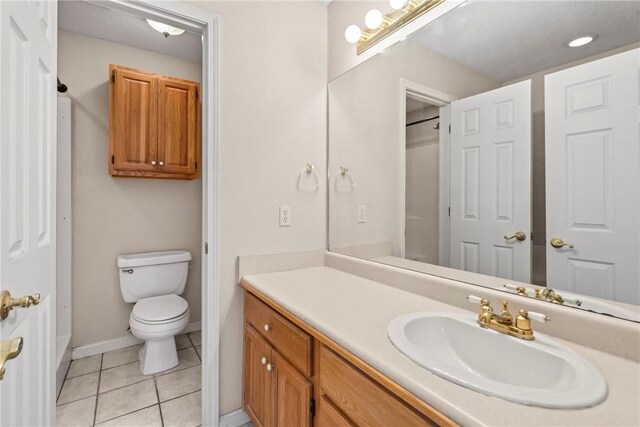 bathroom with tile patterned floors, vanity, and toilet