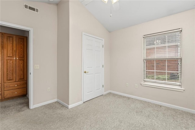 unfurnished bedroom with light carpet, ceiling fan, and lofted ceiling