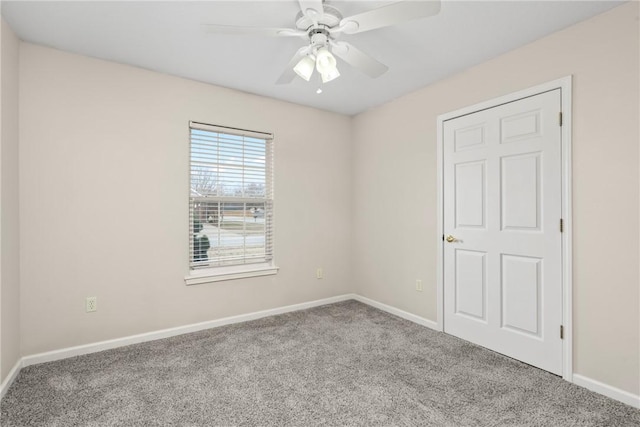 spare room with light carpet and ceiling fan