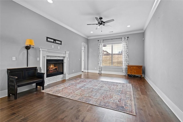 unfurnished room with ceiling fan, dark hardwood / wood-style flooring, and crown molding