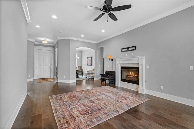 living room with ceiling fan, dark hardwood / wood-style flooring, and crown molding